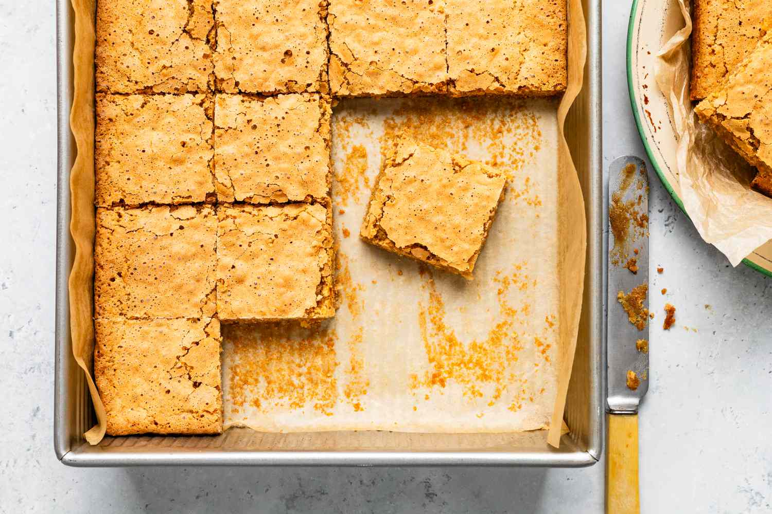 Sad cake on a parchment paper-lined baking pan
