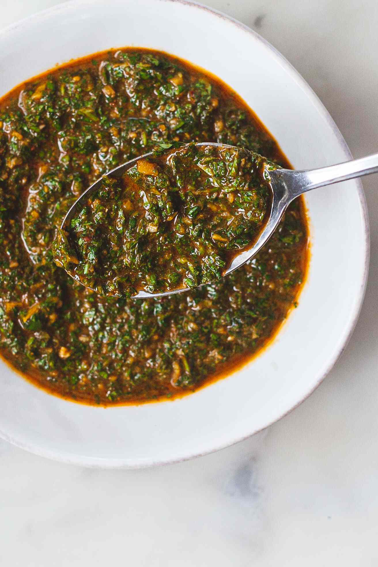 North African Chermoula Relish in a bowl with a spoon.