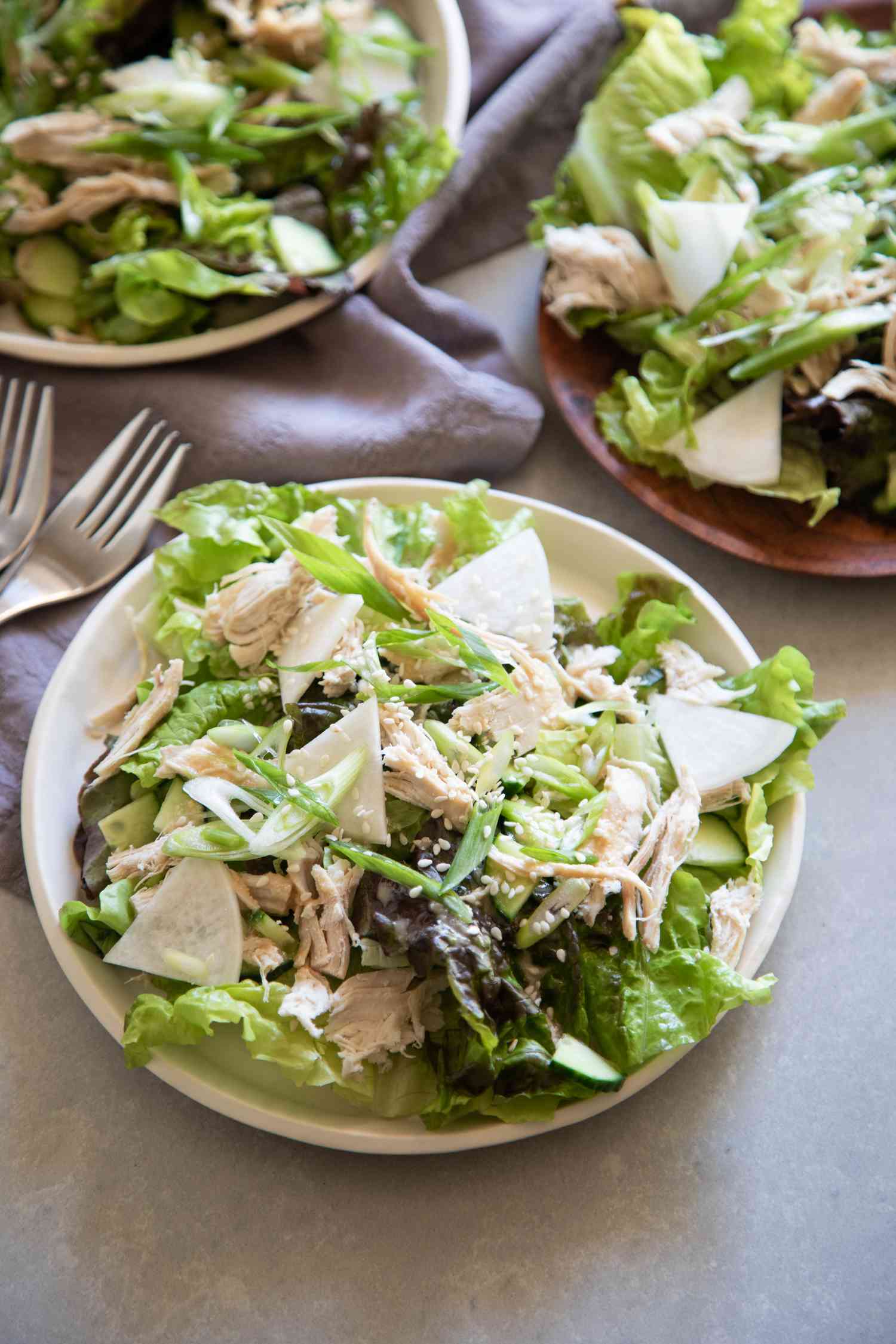 Easy sesame chicken salad in a white bowl.