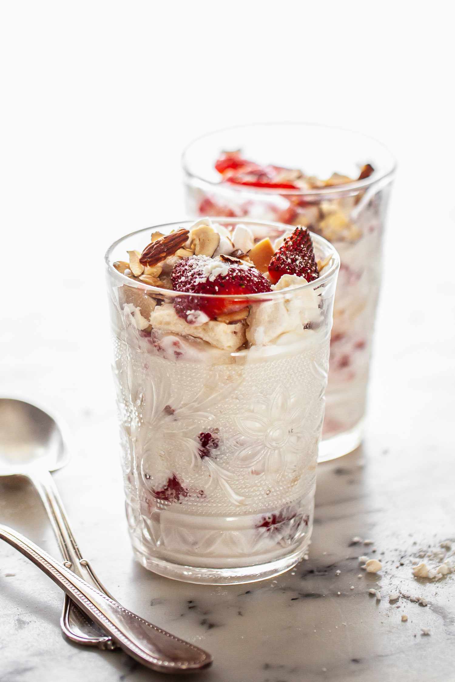 Glasses of Strawberry Eton Mess Next to Spoons