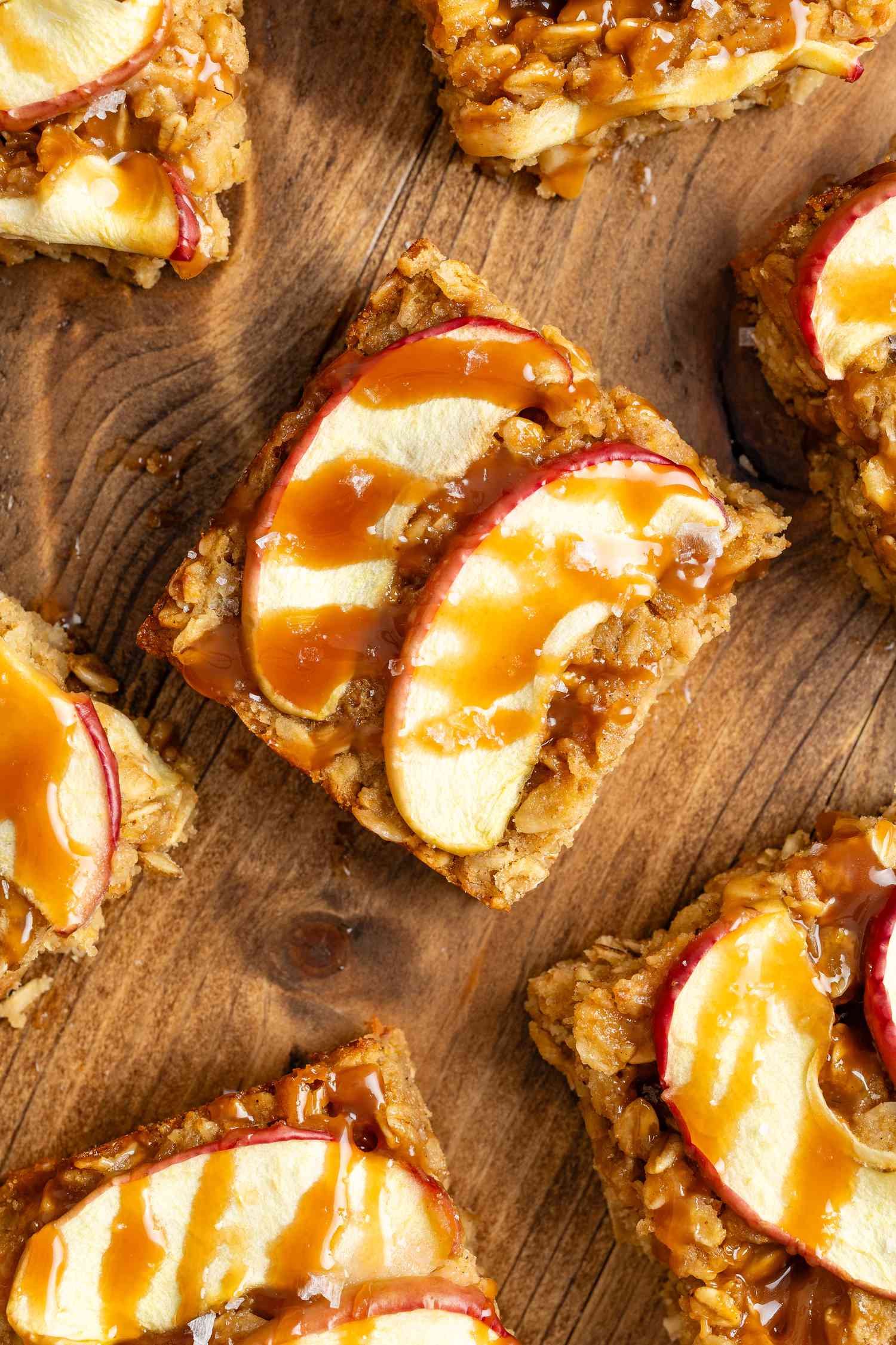 Overhead shot: caramel apple oatmeal bars on a wooden surface