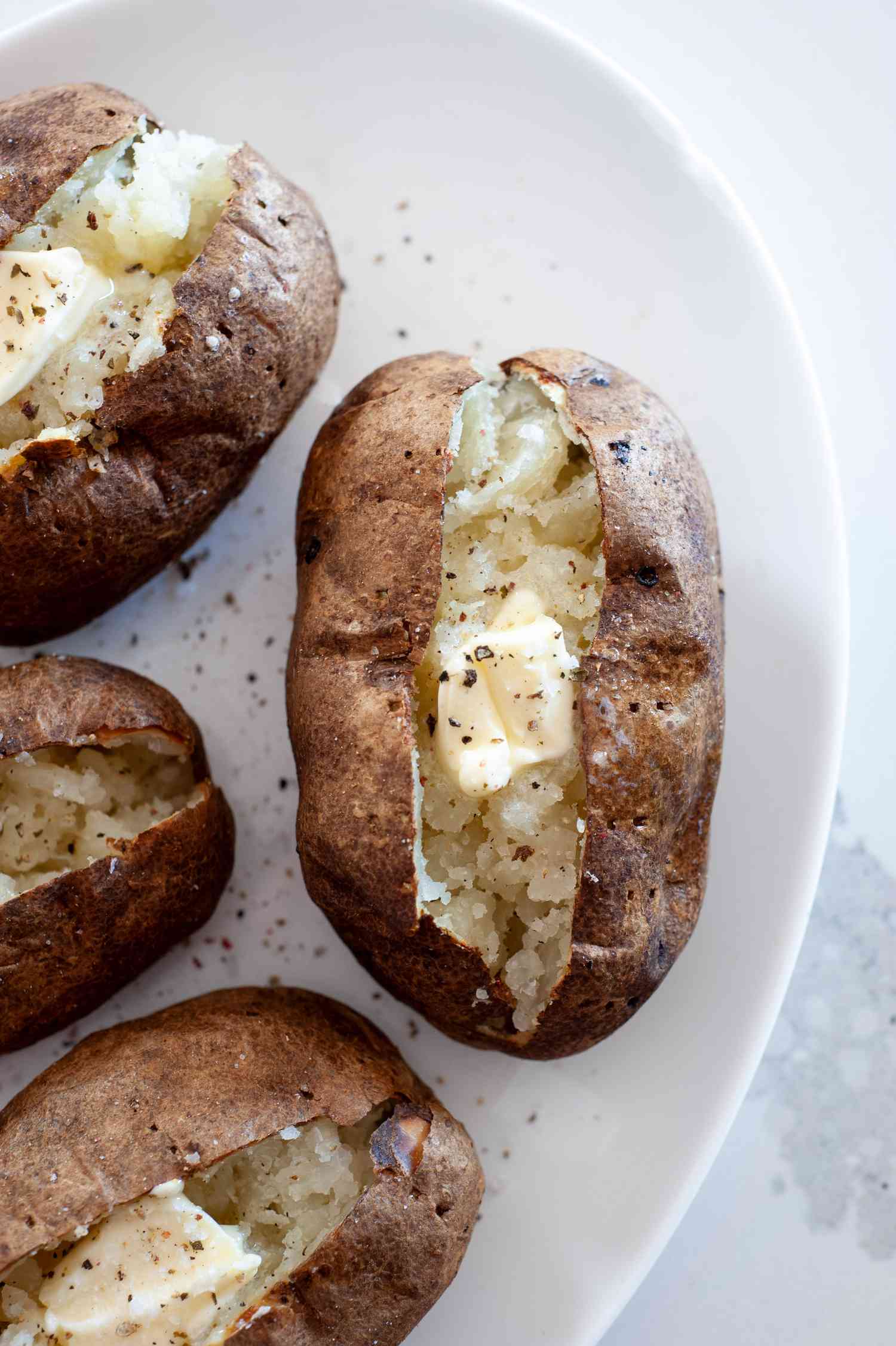 Air Fryer Baked Potatoes Topped with Butter