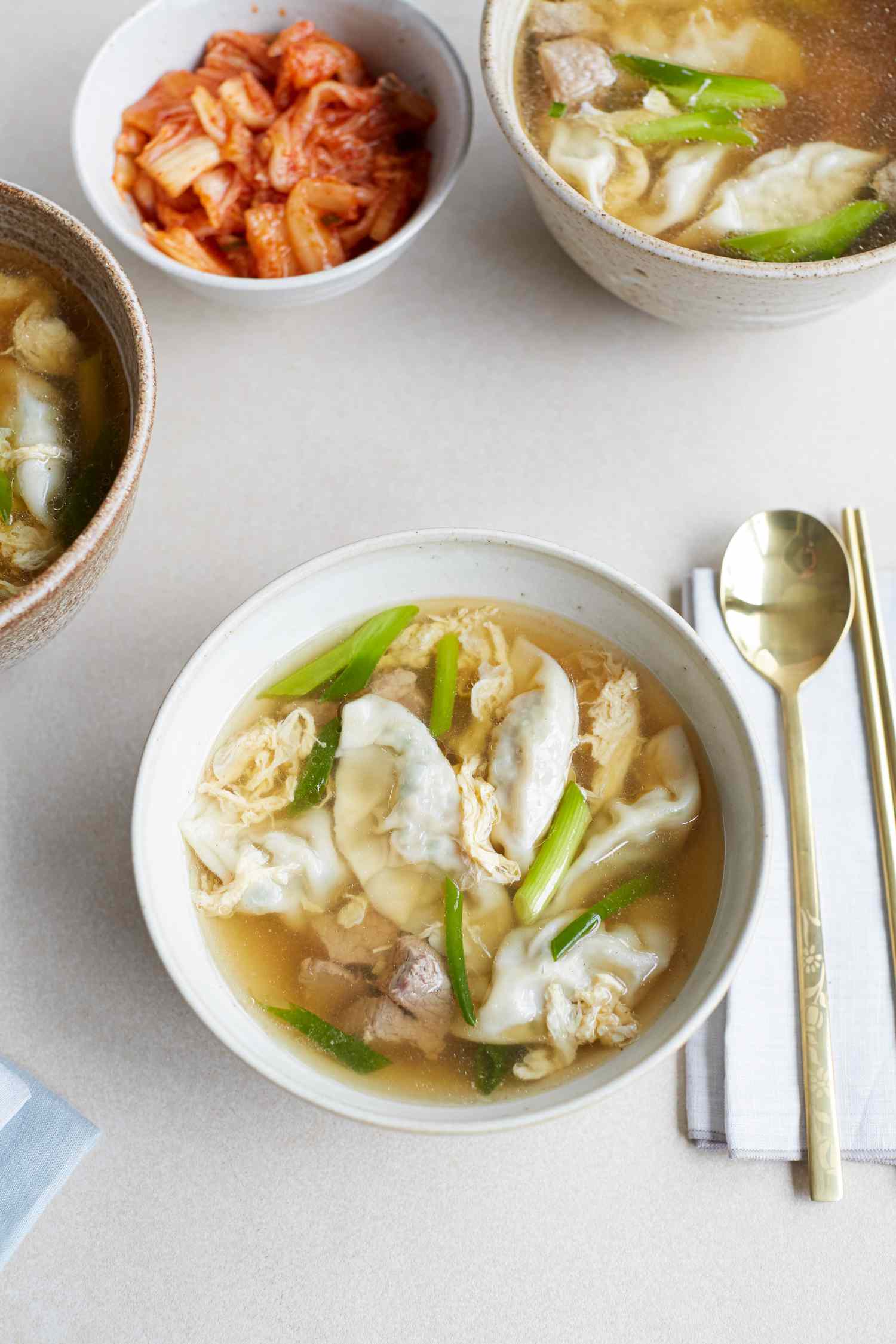 Overhead view of a bowl of beef soup with dumplings.